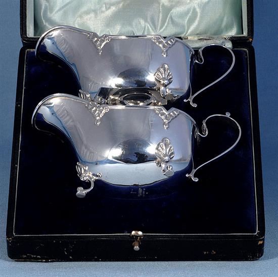 A cased pair of George V silver sauce boats, by Walker & Hall, Length 161mm weight 9.5oz/296grms